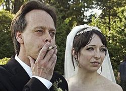 In this July 23, 2006 photo, Marc Emery, Canada’s so-called Prince of Pot, smokes a marijuana joint at his marriage to his wife Jodie in Vancouver, British Columbia.